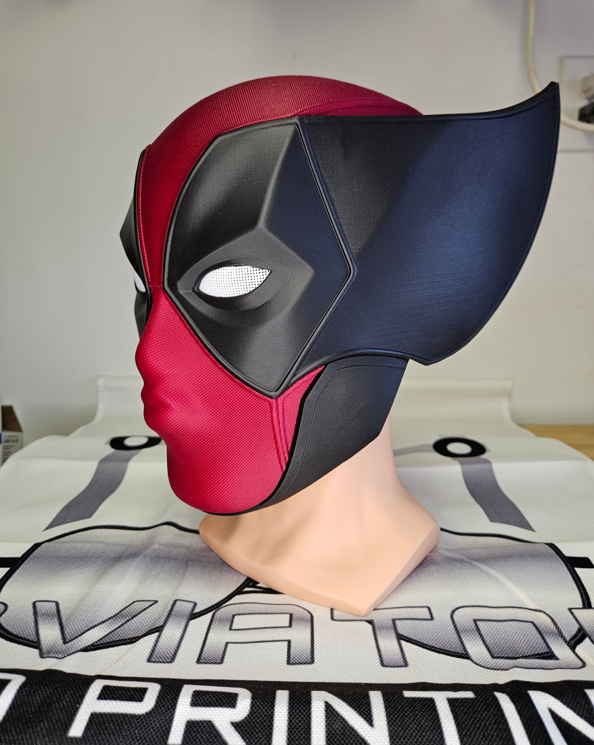 Deadpool and Wolverine mash up helmet. 3D Printed Poolverine cosplay prop by Aviator 3D Printing. Treat yourself or gift to a special person. Great for home office display, or to wear anytime. Get yours before the next Marvel Deadpool and Wolverine movie.