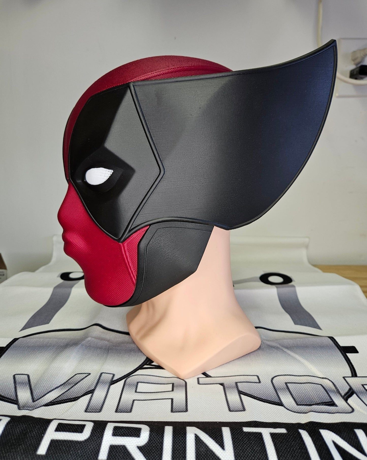 Deadpool and Wolverine mash up helmet. 3D Printed Poolverine cosplay prop by Aviator 3D Printing. Treat yourself or gift to a special person. Great for home office display, or to wear anytime. Get yours before the next Marvel Deadpool and Wolverine movie.