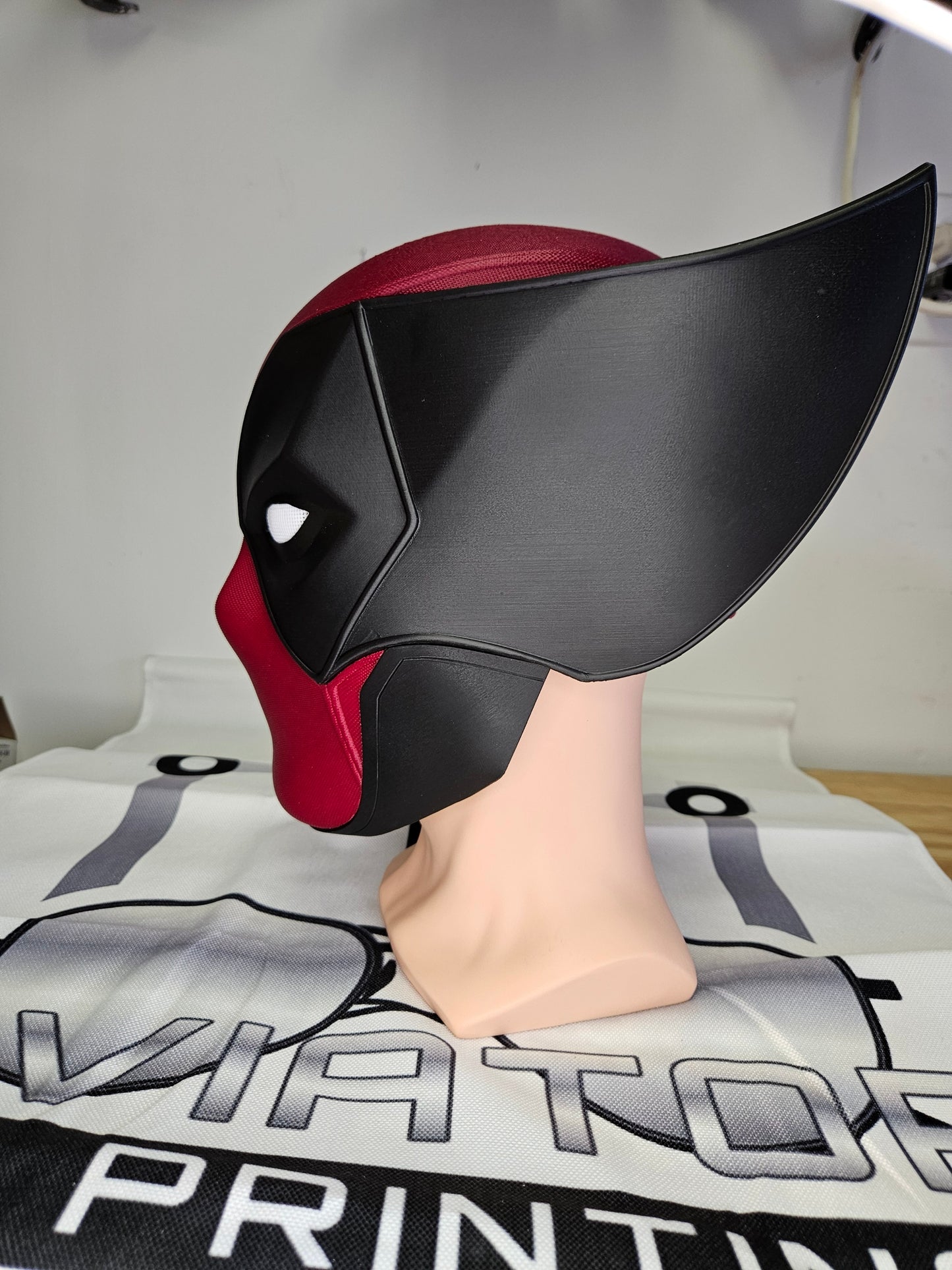 Deadpool and Wolverine mash up helmet. 3D Printed Poolverine cosplay prop by Aviator 3D Printing. Treat yourself or gift to a special person. Great for home office display, or to wear anytime. Get yours before the next Marvel Deadpool and Wolverine movie.